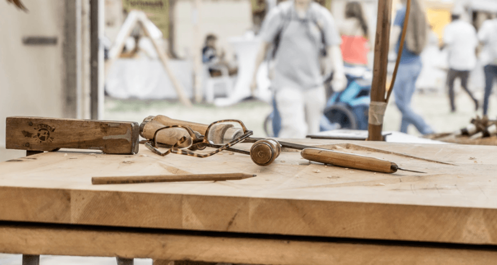 wood engraving tools with glasses on a woodworking bench