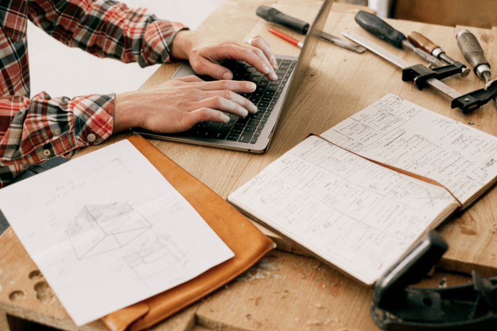 Man on laptop choosing best easy halloween scrollwork patterns