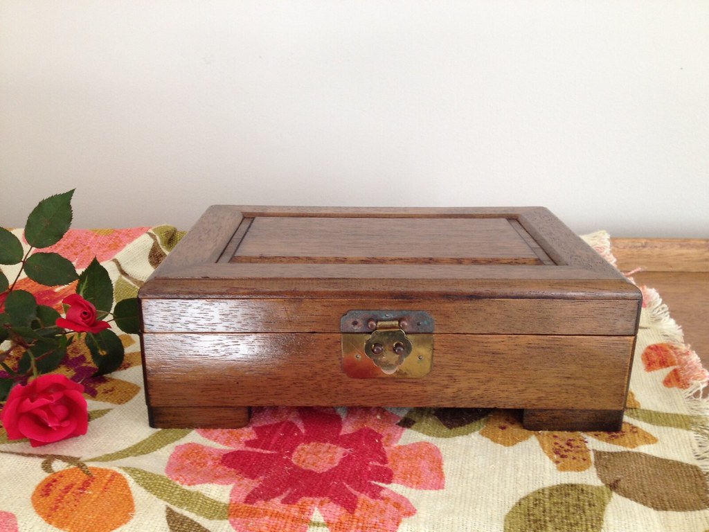 Vintage Wooden Jewelry Box on flower table cloth